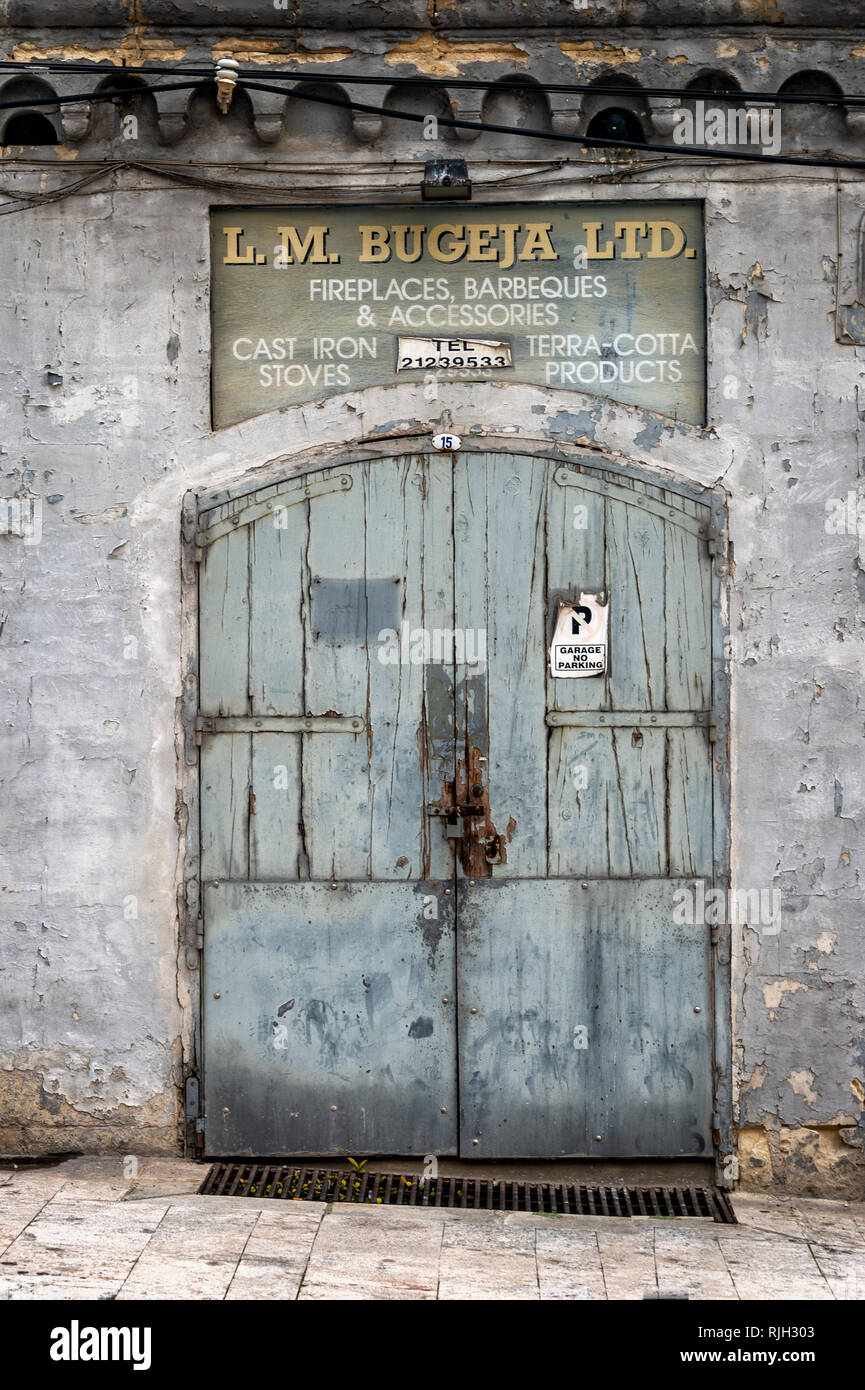 old wooden painted doors to a shop / warehouse in valletta, Malta. Stock Photo