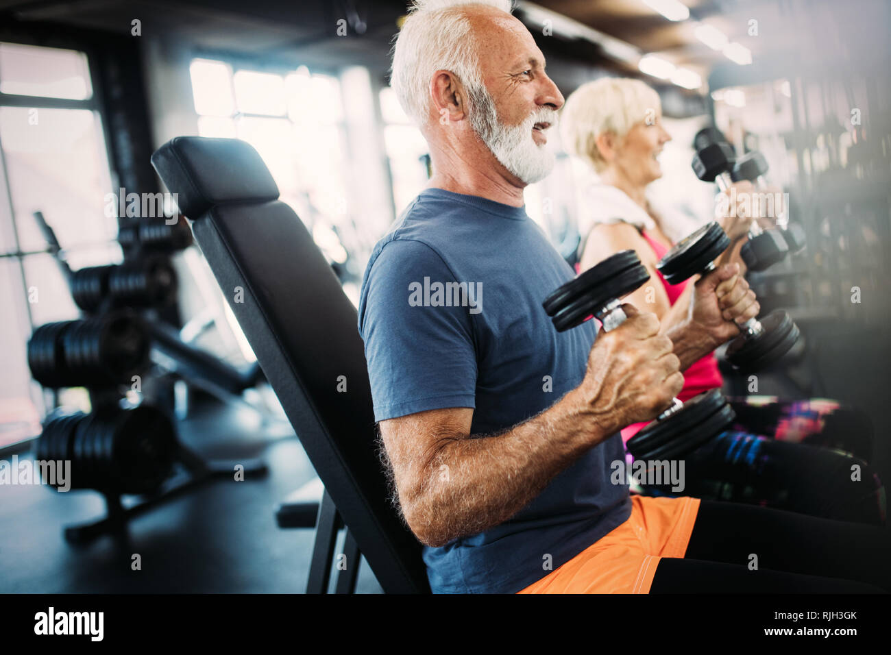Fit Senior Sporty Couple Working Out Together At Gym Stock Photo Alamy
