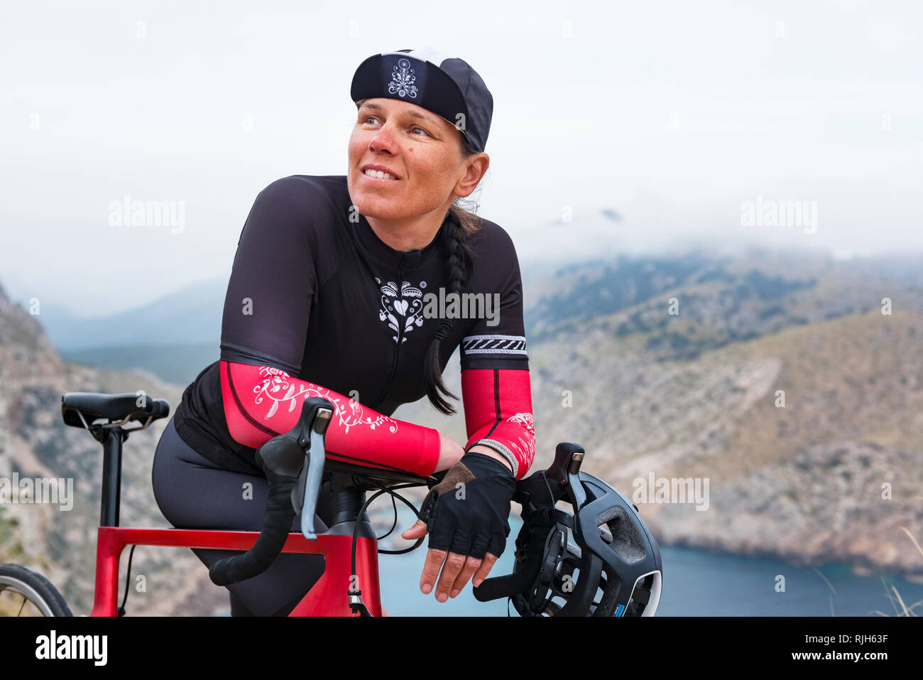 Woman in cycling clothes resting Stock Photo