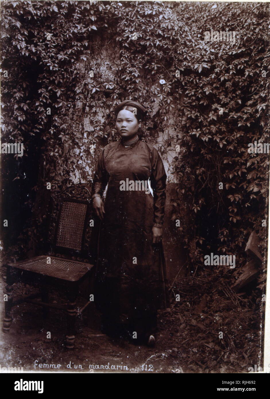 Vietnamese woman in smart traditional dress; Colonial era photograph; 1890 Stock Photo