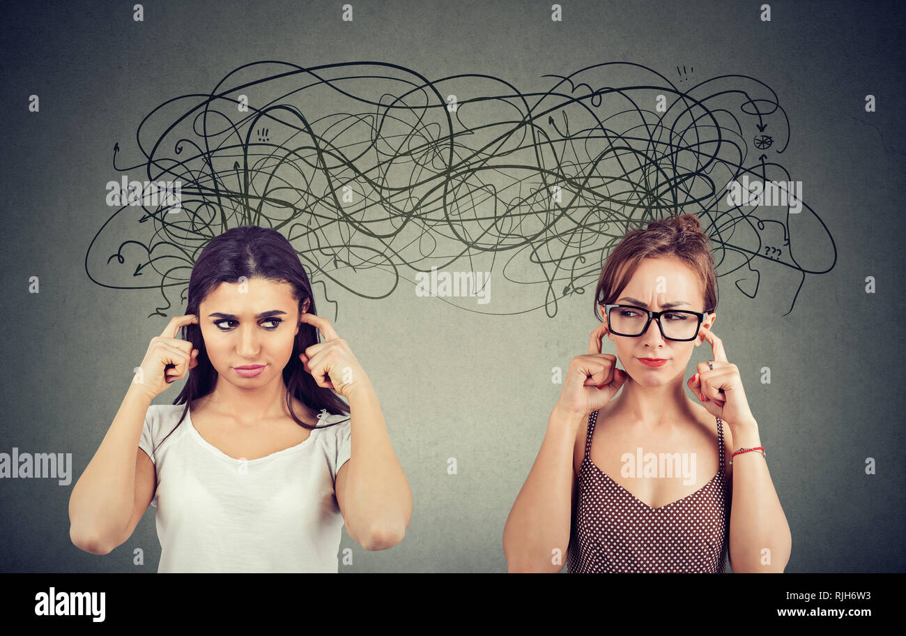 Two angry displeased with each other women ignoring not listening each other exchanging with many negative thoughts Stock Photo