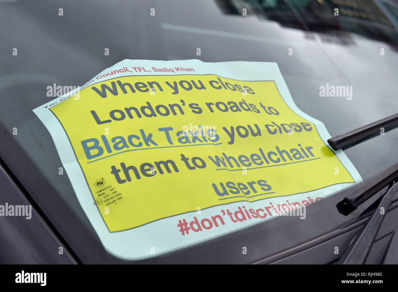 A sticker in the window of a taxi during a demonstration by taxi drivers in Parliament Square, central London, in the latest stage of ongoing protests against Camden Council's plans to restrict their access to parts of Tottenham Court Road. Stock Photo