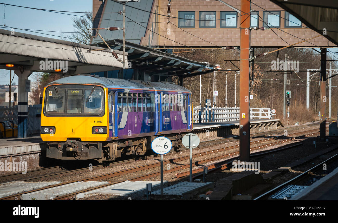 Class 144 Pacer diesel multiple unit train in Northern livery waiting at a station, on it's way to Leeds, UK. Stock Photo