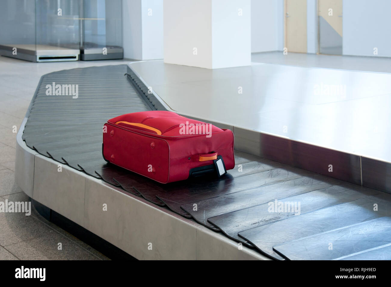Suitcase on airport conveyor belt Stock Photo
