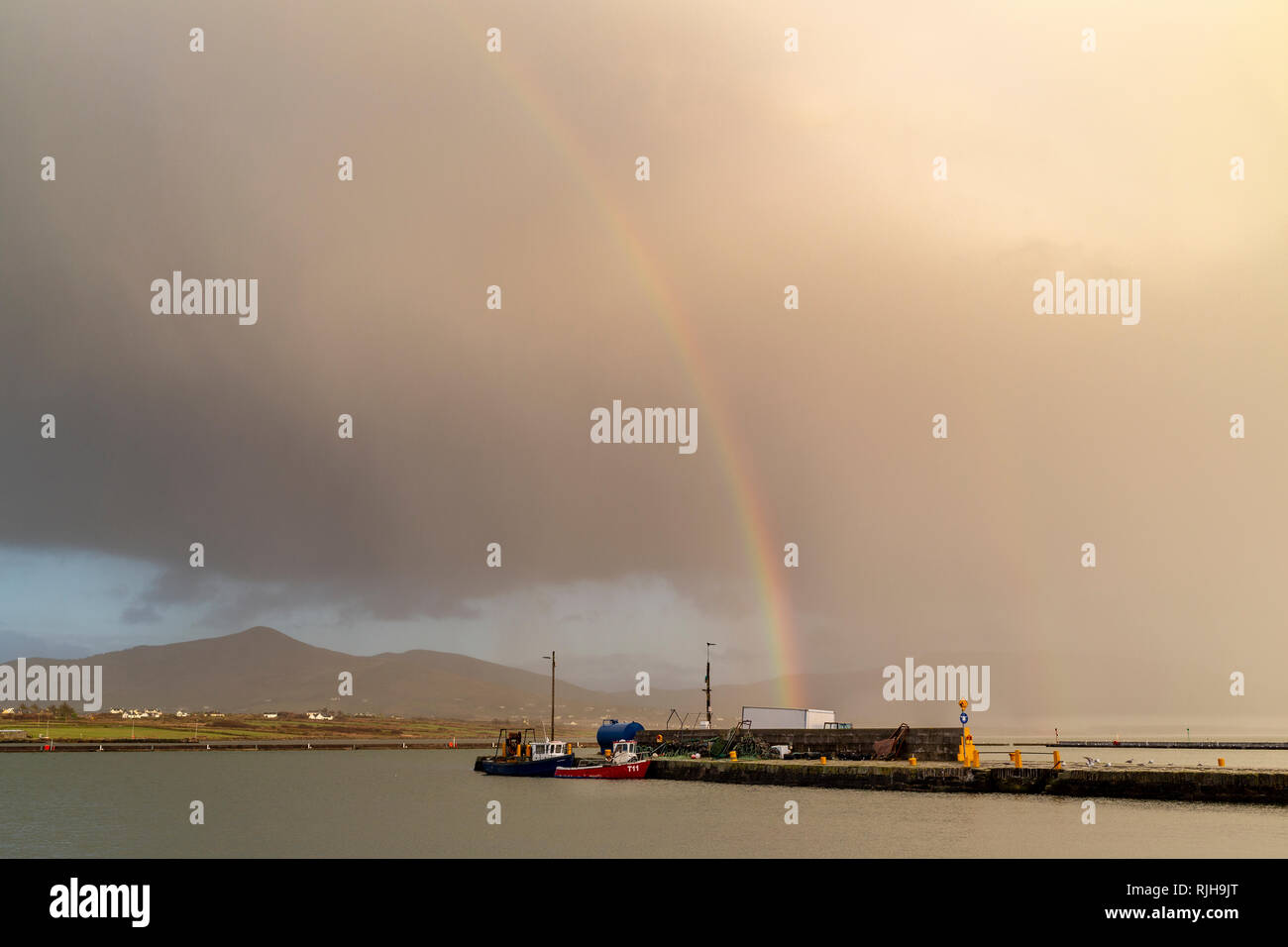 Dark clouds and rainbow over Valentia Island County Kerry, Ireland Stock Photo