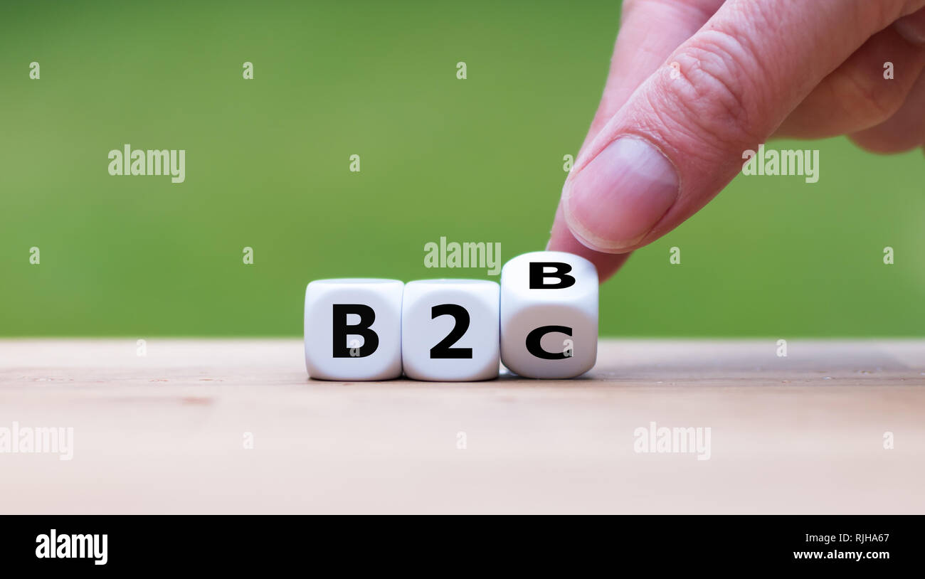 Business to Business or Busness to Consumer? Hand turns a dice and changes the expression 'B2B' to 'B2C' (or vice versa) Stock Photo