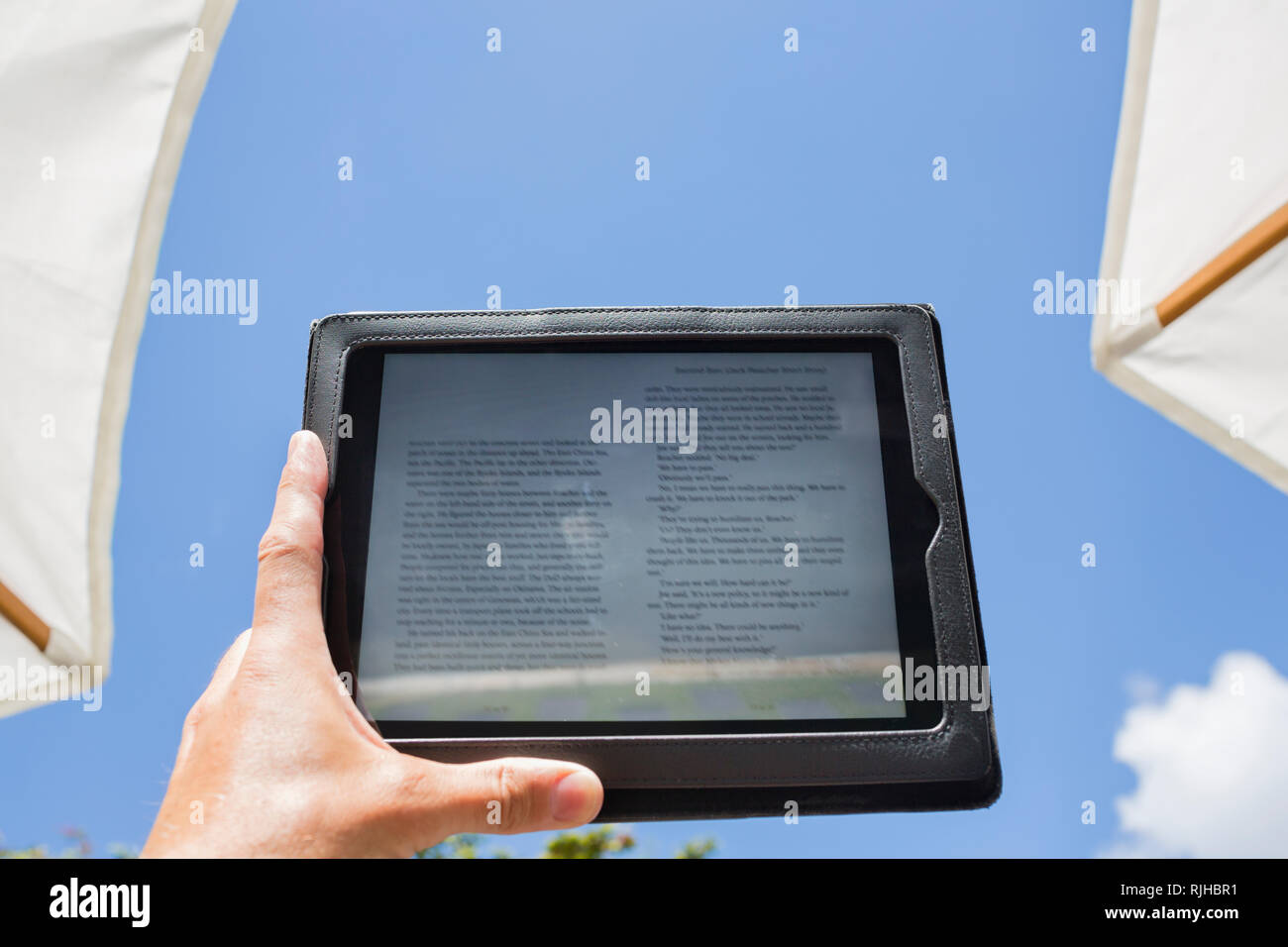 Hand holding book reader Stock Photo Alamy