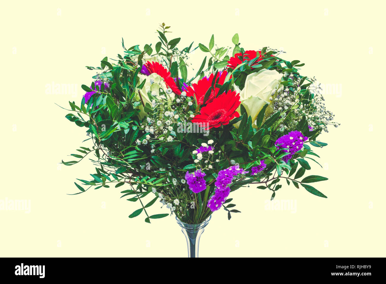 Heart shaped bunch of colorful spring flowers. Concept for the spring or summer season, weddings and valentines day. Stock Photo
