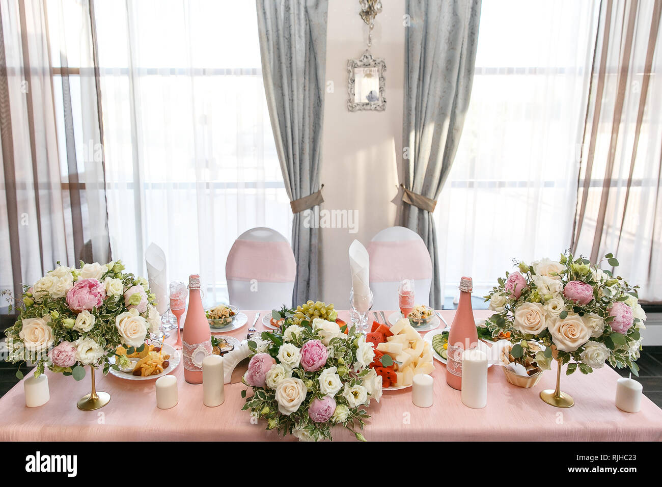 Decoration of a wedding table of newlyweds, candles, candlestick, fresh