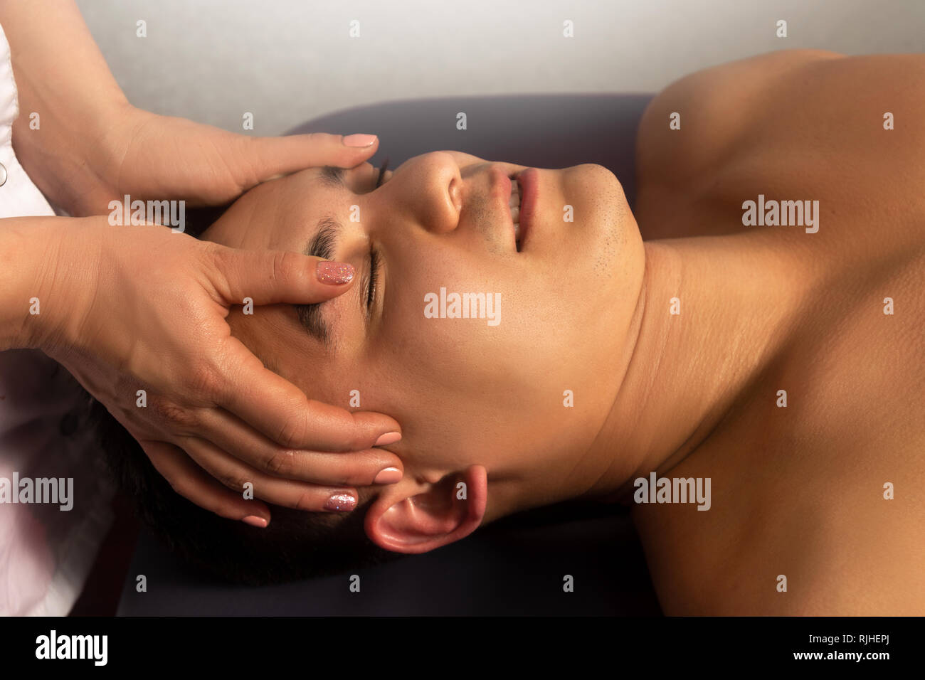Male massage. Rehabilitation therapy. Sport recreation concept. Healthy background. Beauty and spa salon. Stock Photo