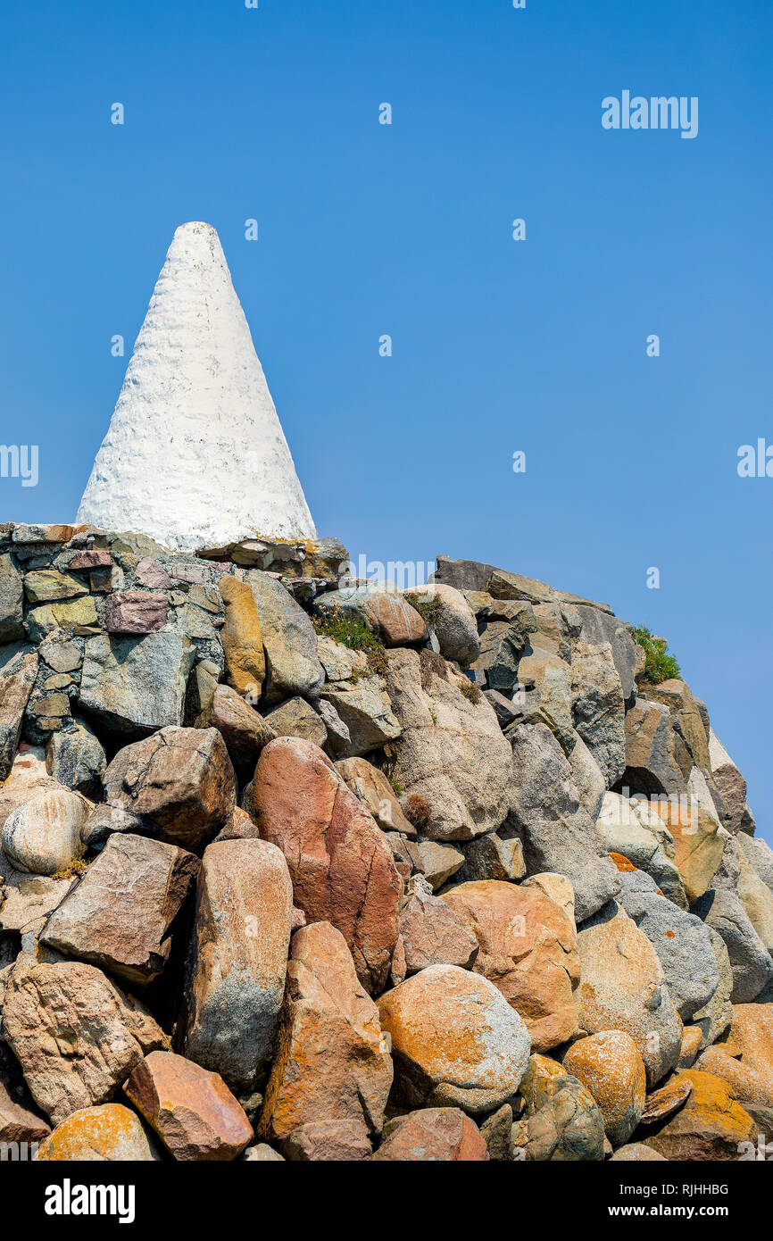 Close up of the navigation cone and stone breakwater in Braye Harbour on Alderney Channel Islands. Stock Photo