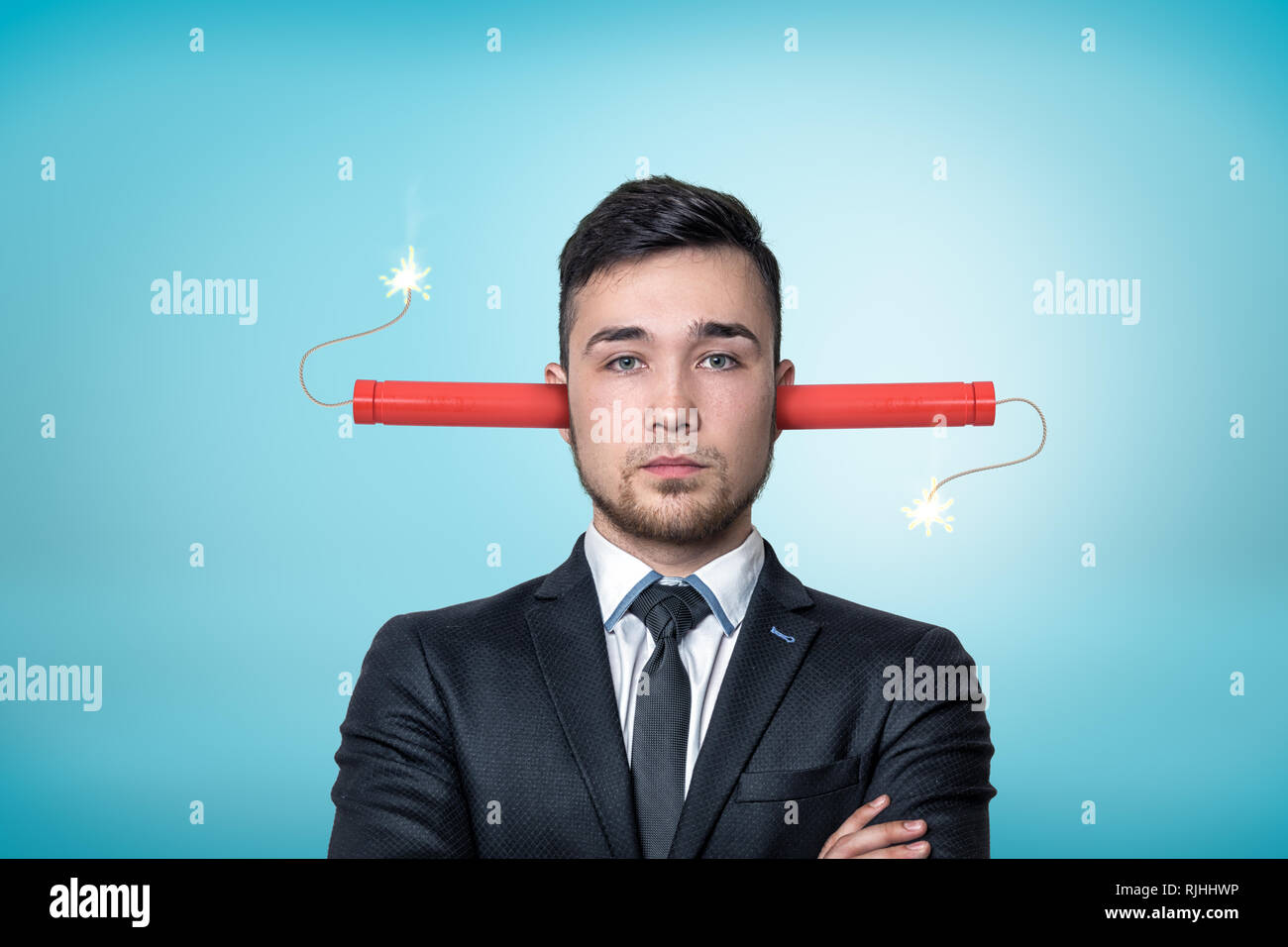 Crop view of a businessman, arms folded, burning dynamite sticks up his ears, on a light-blue background Stock Photo - Alamy Crop view of a businessman, arms folded, burning dynamite sticks up his ears, on a light-blue background Stock Photo - Alamy