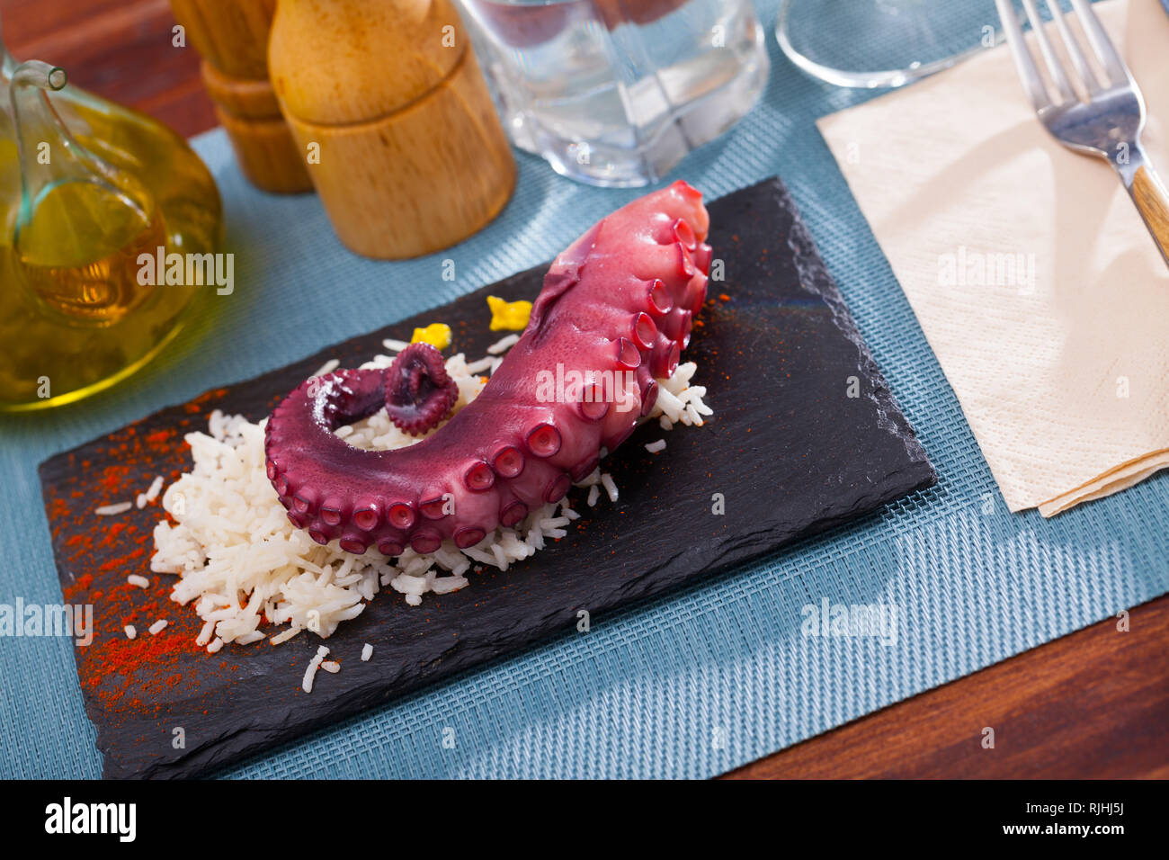 Delicious cooked octopus tentacles on a chopping board Stock Photo - Alamy
