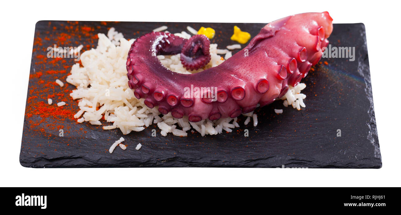Seafood dish – boiled octopus with rice served with paprika and sauce ...