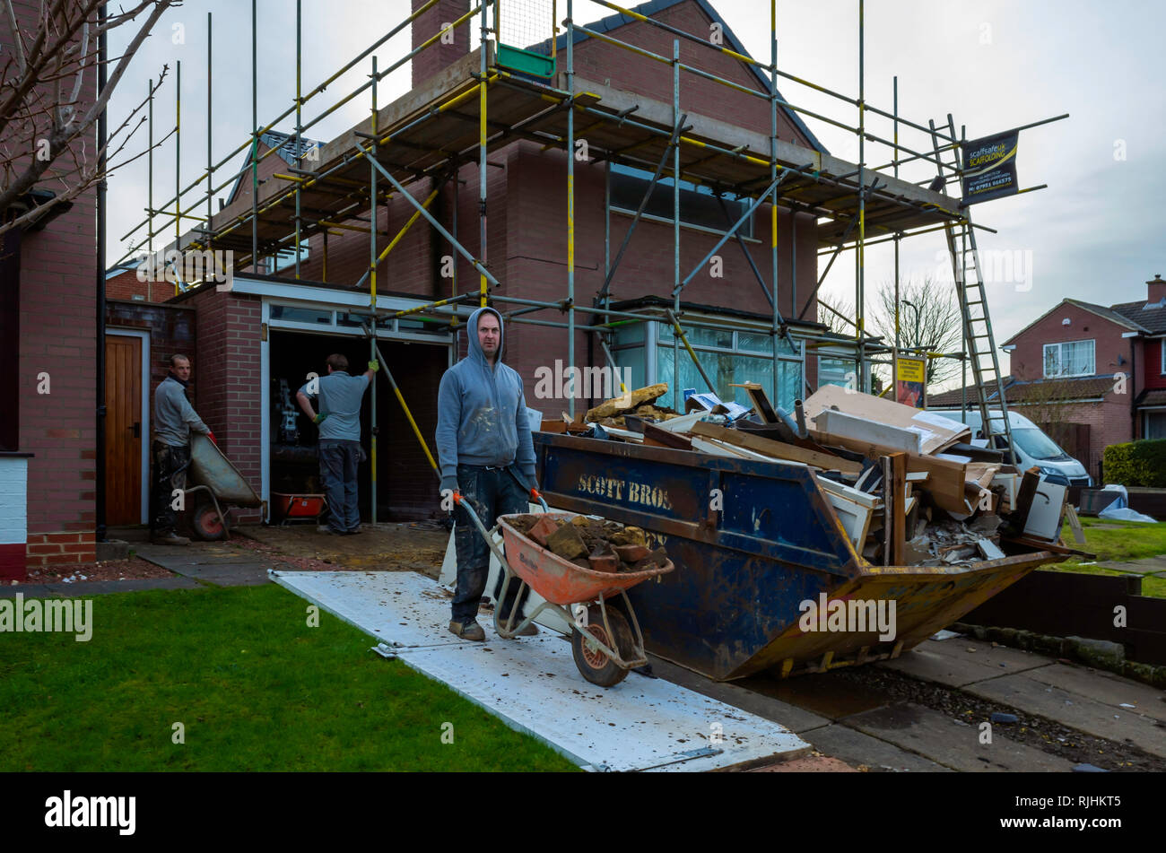 Builders carrying out a major refurbishment of a residential house in a North Yorkshire Village Stock Photo