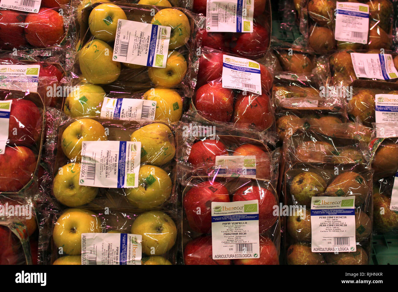 Fruit stacked in plastic packs on a supermarket Stock Photo