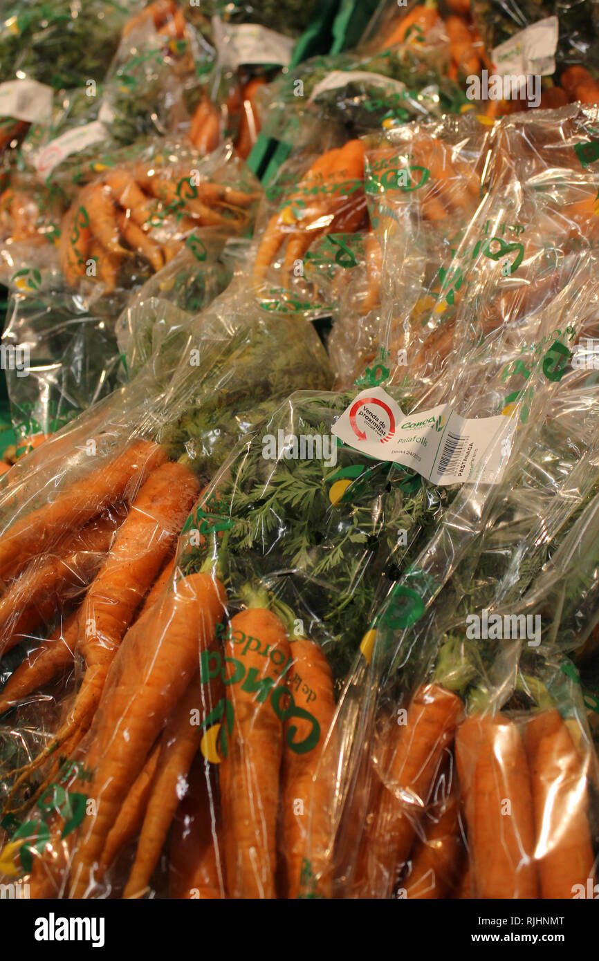 Display of carrots vegetable in plastic packaging on a supermarket Stock Photo