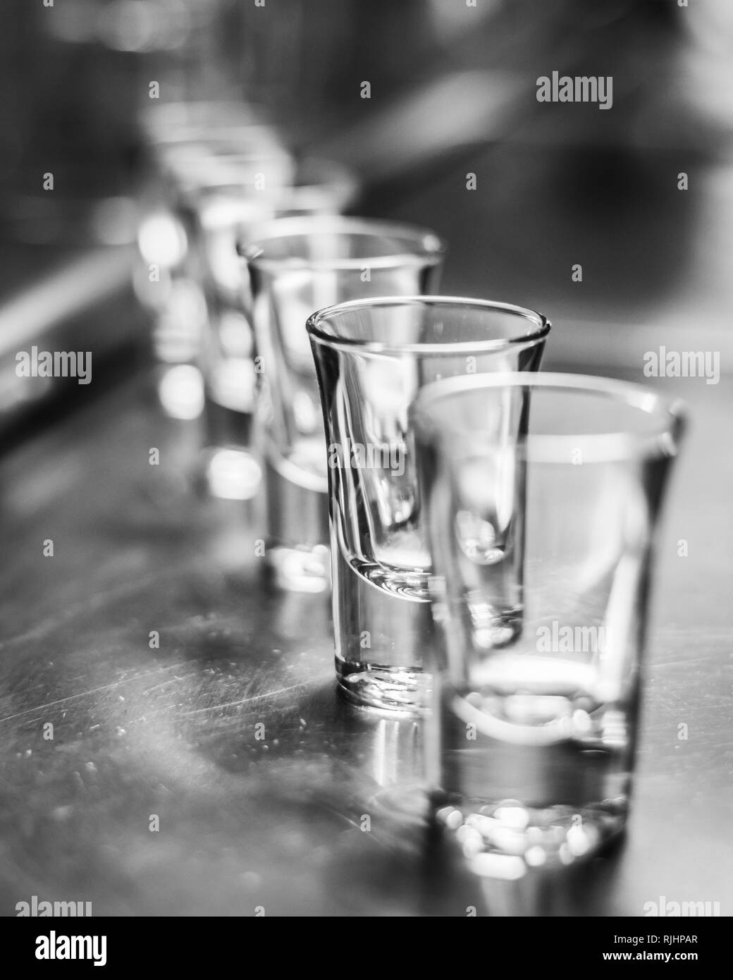 Row of empty nigthclub glasses. Stock Photo
