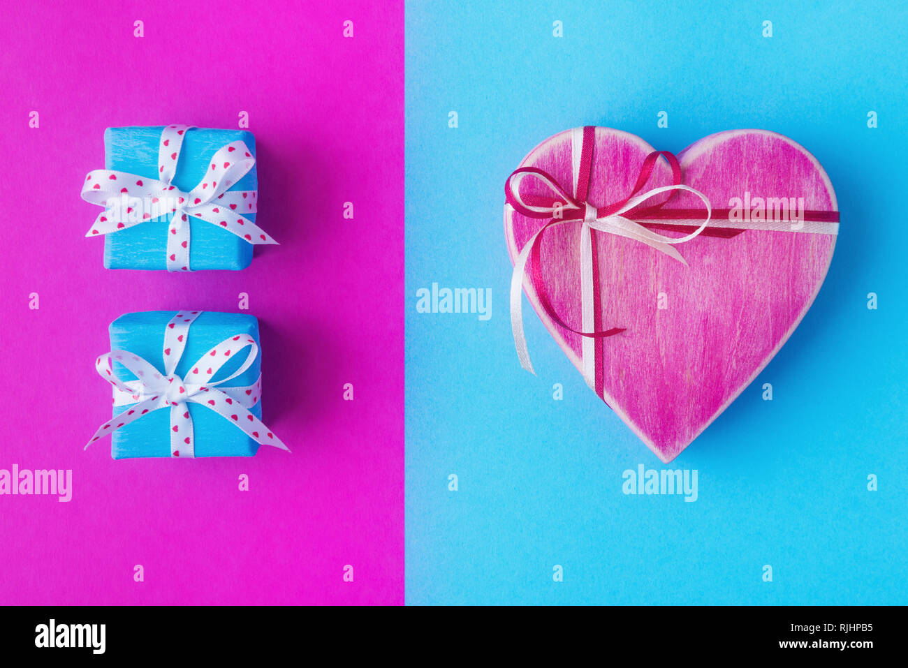 Gift boxes over pink and blue backdrop. Valentines day background Stock Photo