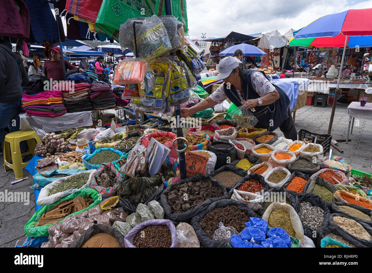 Otavalo, Ecuador - September 23, 2018: a street vendor selling locally spices and herbs in the Saturday open air market Stock Photo