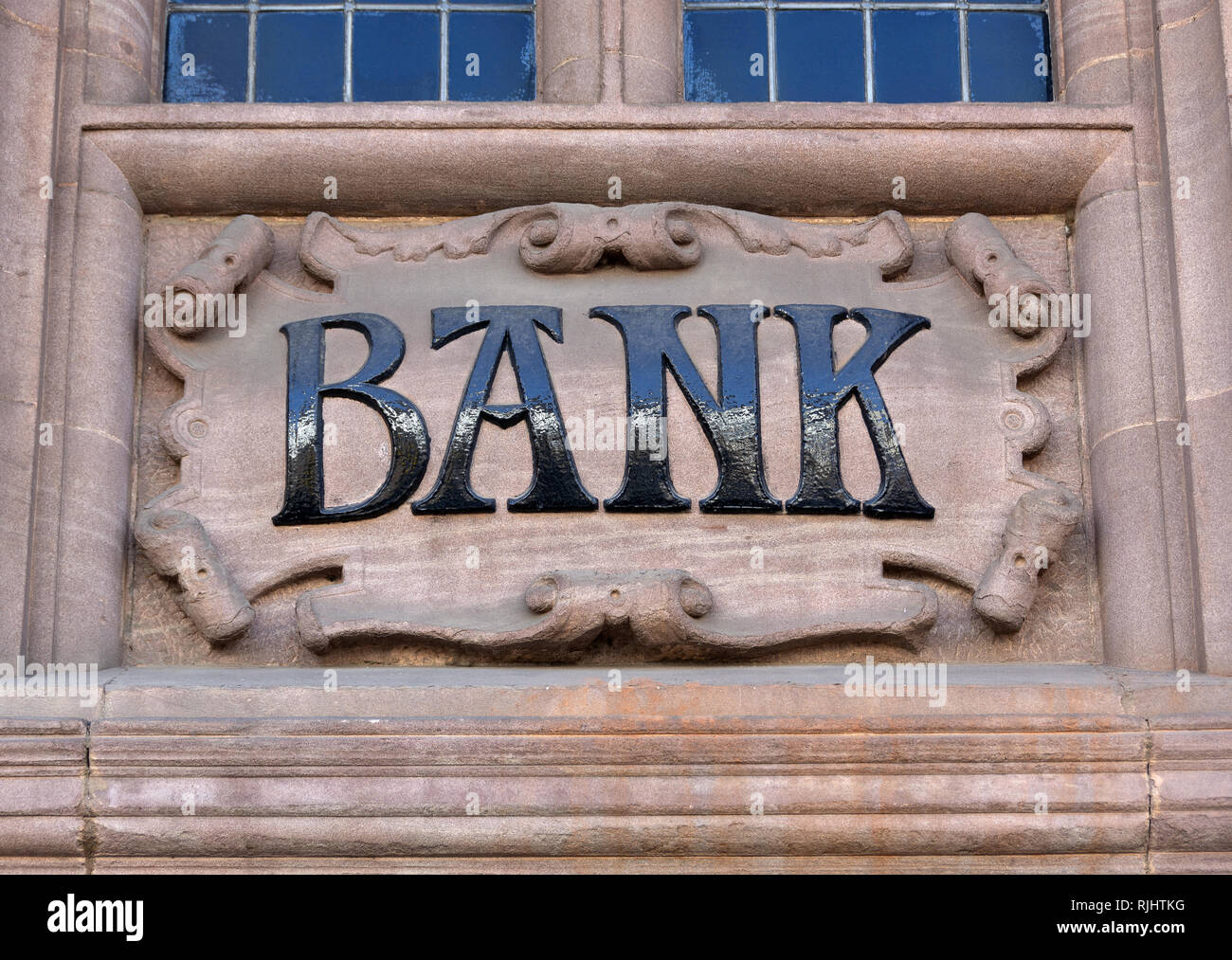 Stone carving of the word bank on the exterior of building Stock Photo