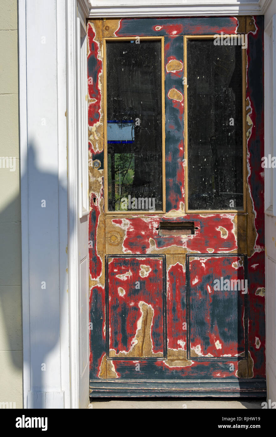 Stripped back wooden door with street light shadow Stock Photo