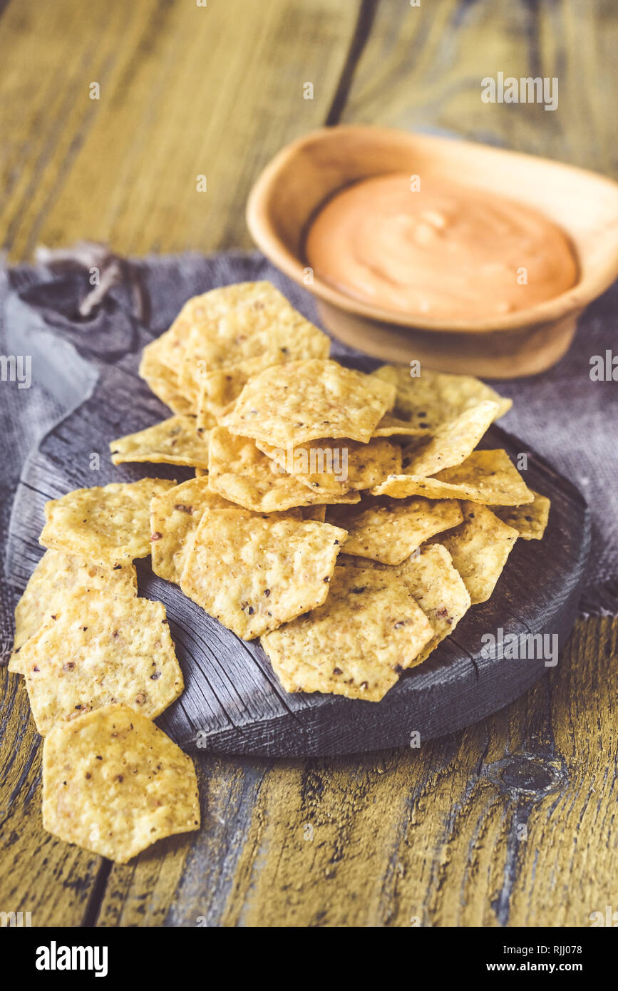 Tortilla chips with chile con queso dip made of melted cheese and