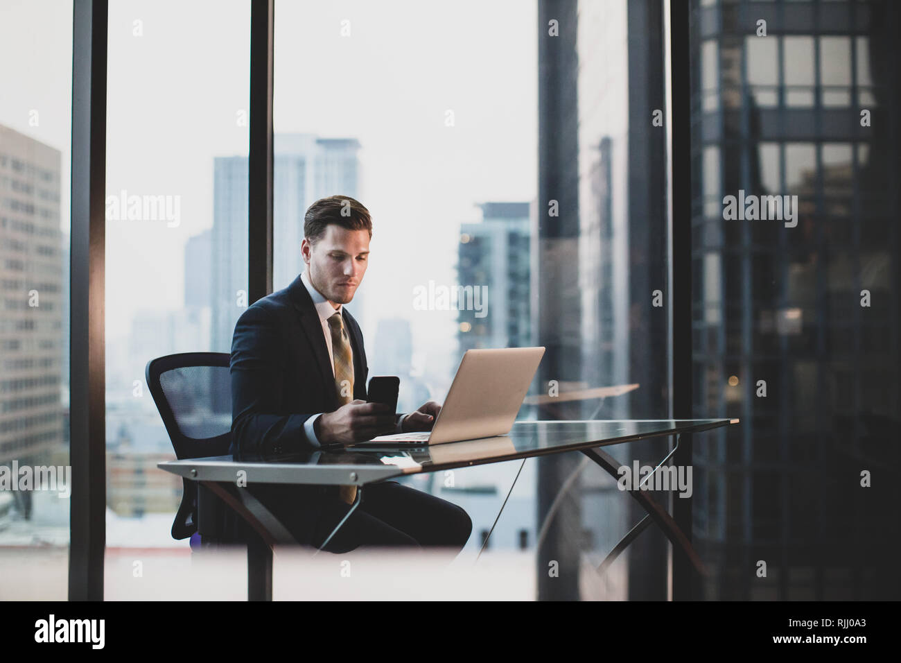 Businessman working in executive office in a skyscraper Stock Photo