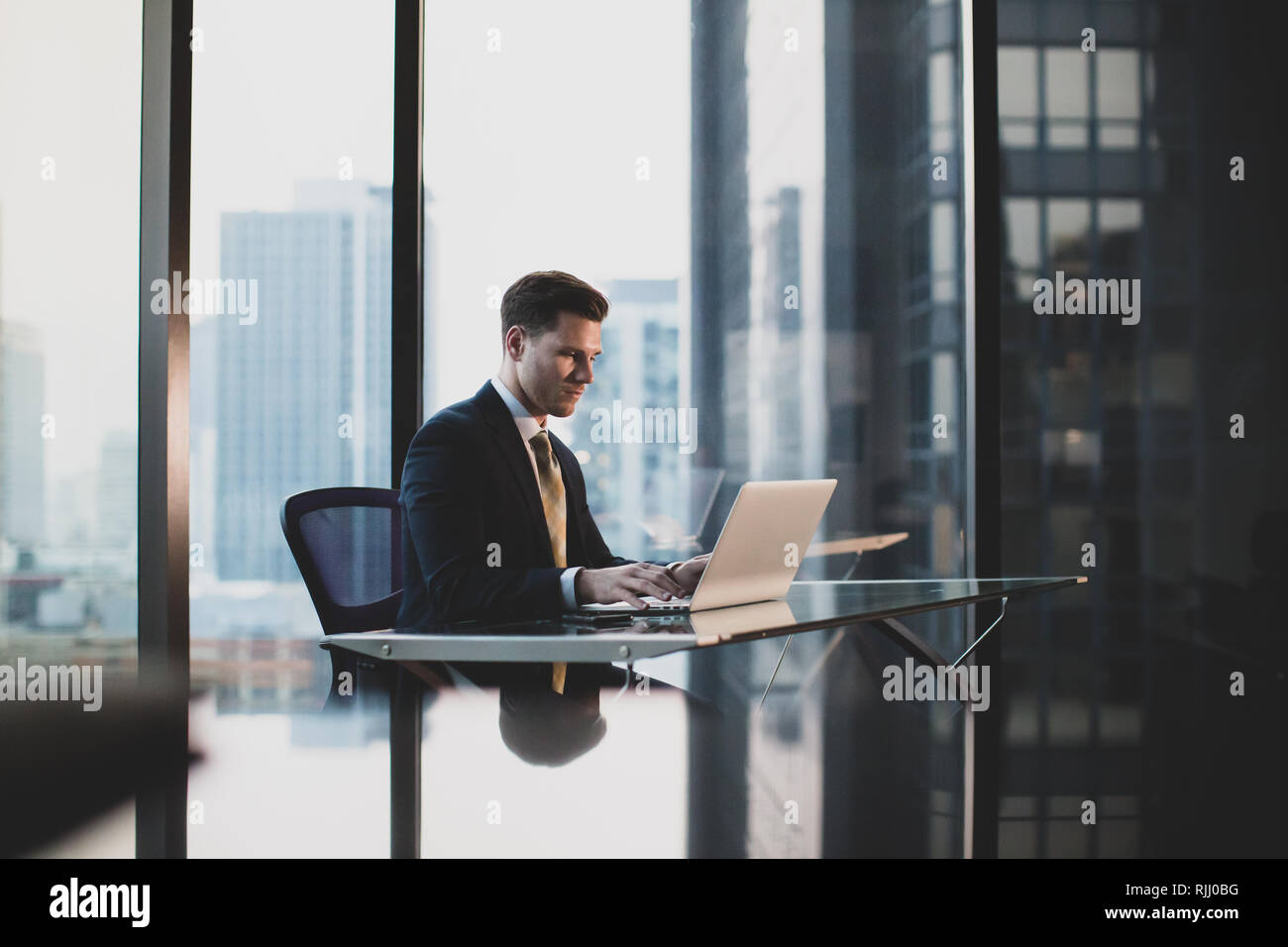 Businessman working in executive office in a skyscraper Stock Photo