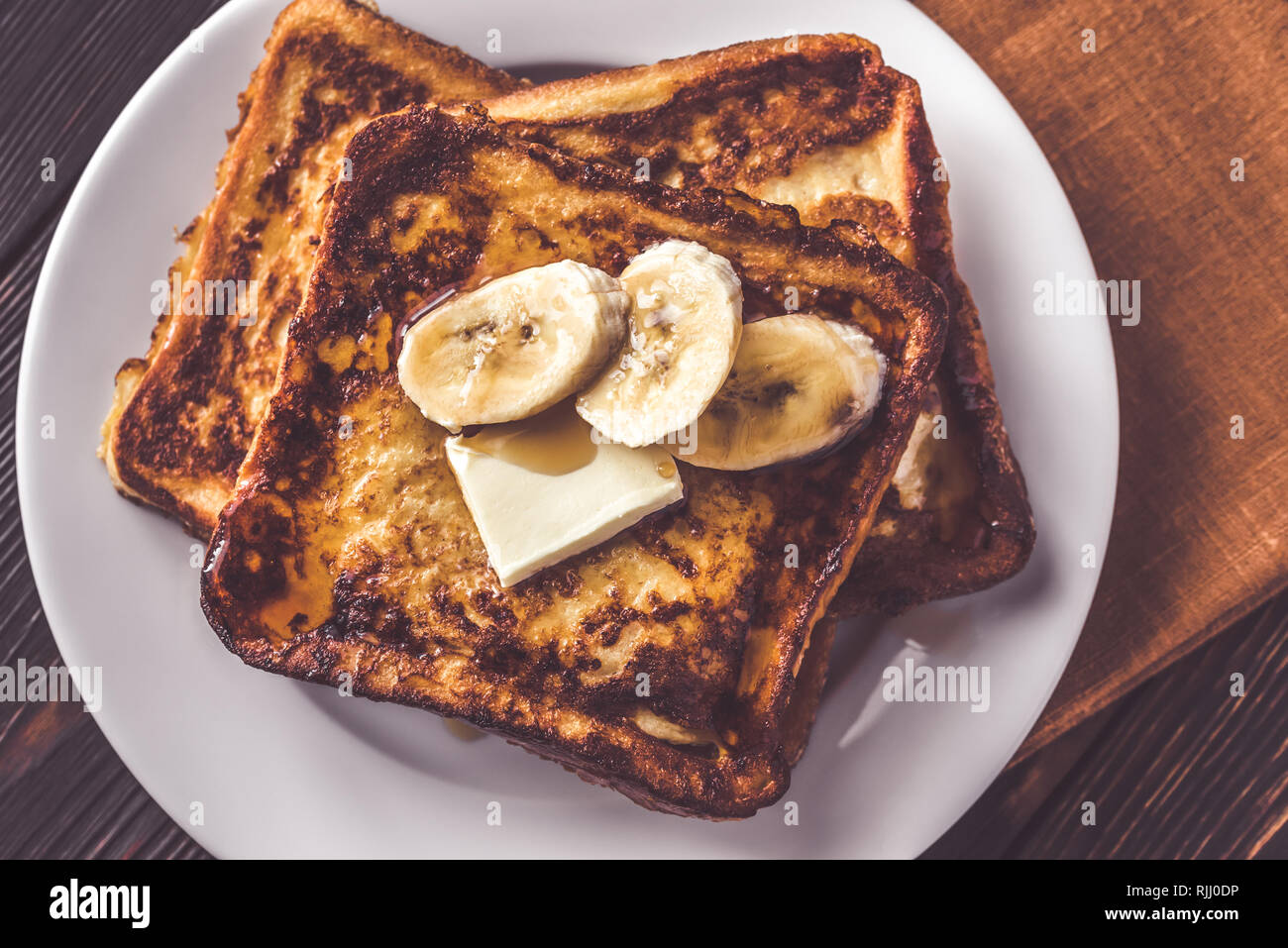 French Toast With Butter Sliced Banana And Maple Syrup Stock Photo Alamy