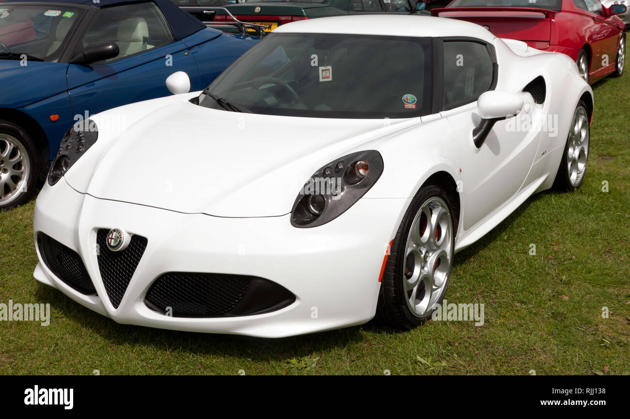 Three-quarter front view of a  White Alfa Romeo 4C on display in the Car Club Zone of the 2017 Silverstone Classic Stock Photo