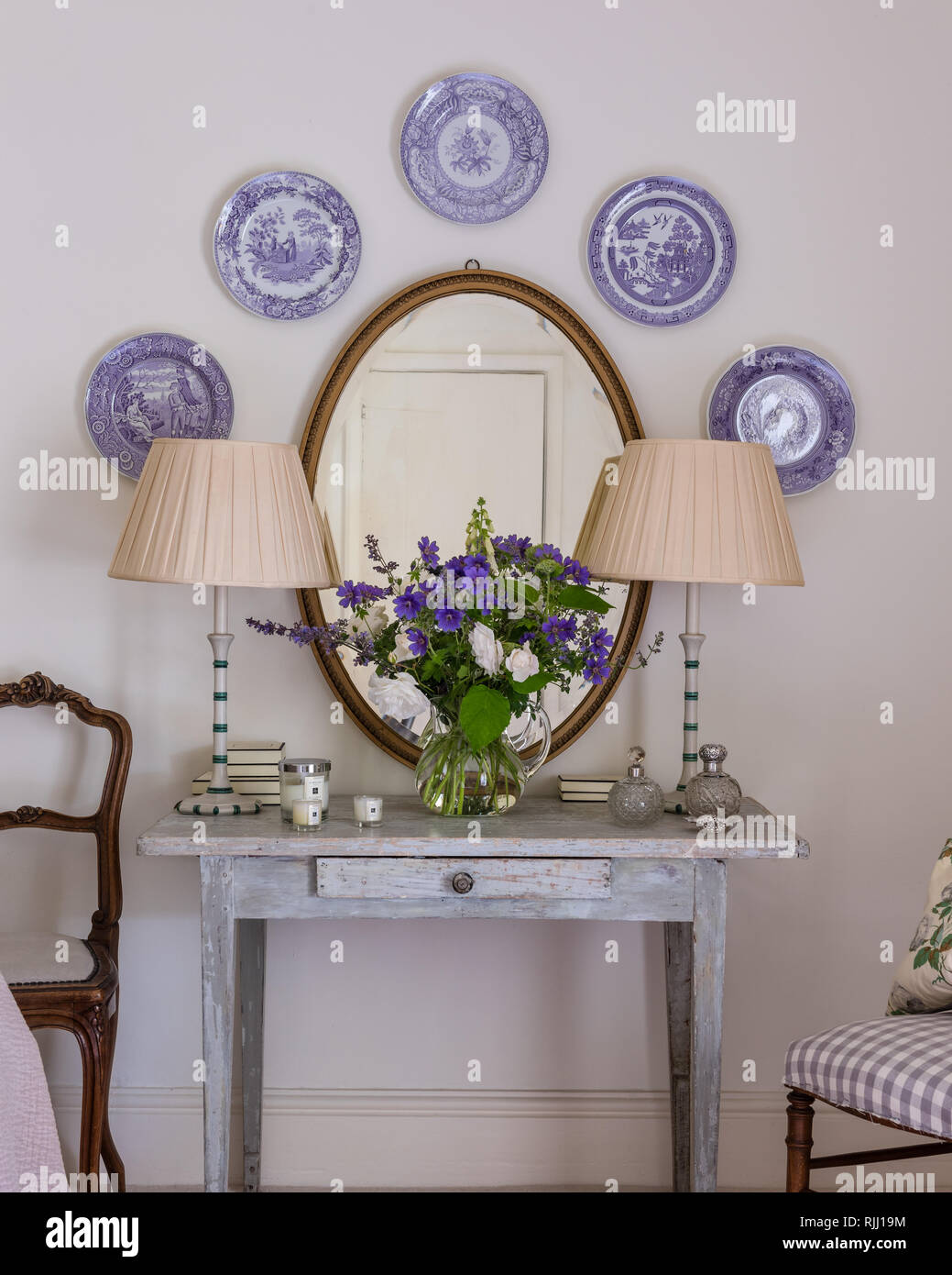 Antique Wedgwood plates displayed above old wooden table Stock Photo