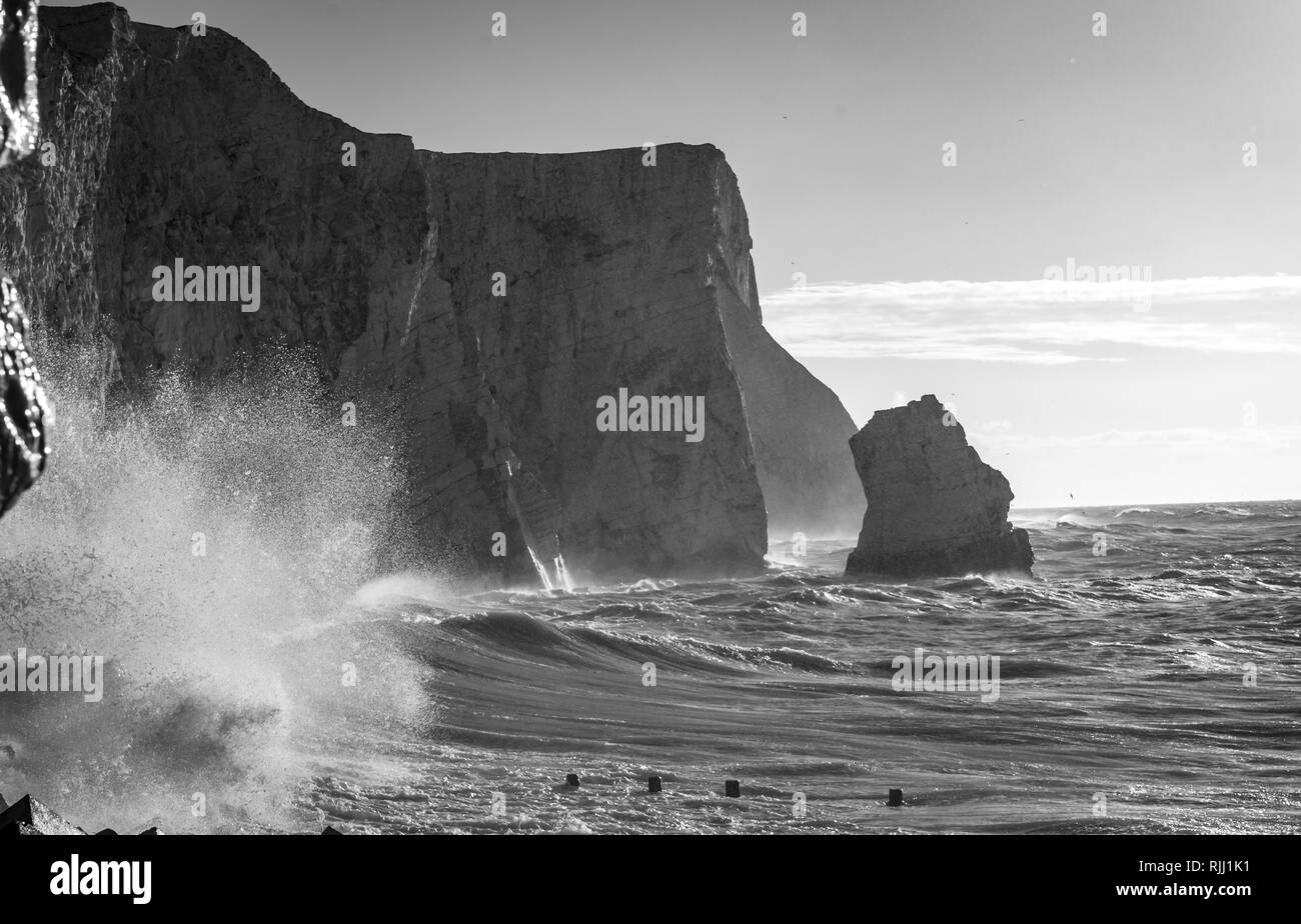 waves crashing into chalk cliffs Stock Photo