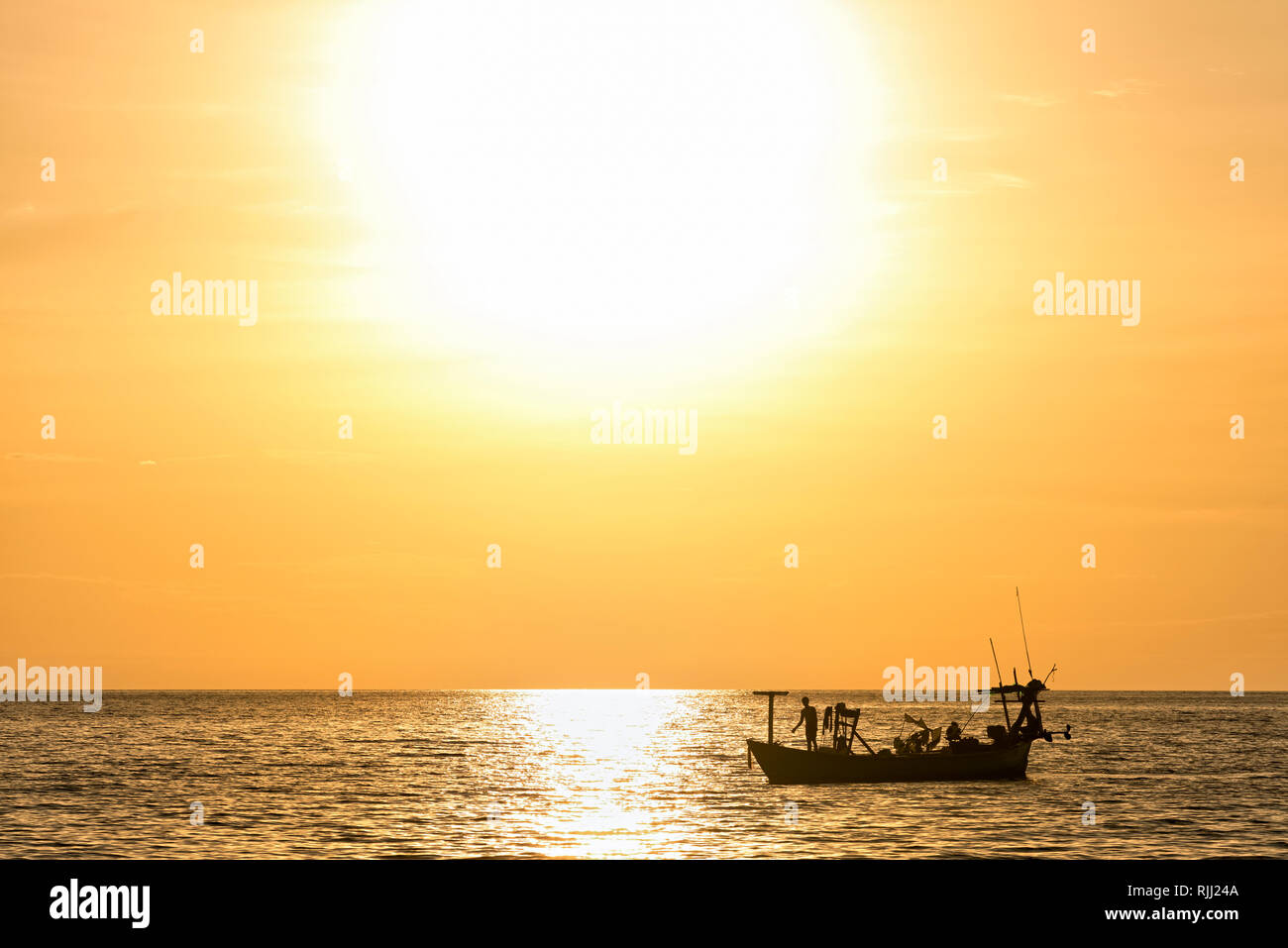 Silhouette of fishing boat during sunset Stock Photo - Alamy