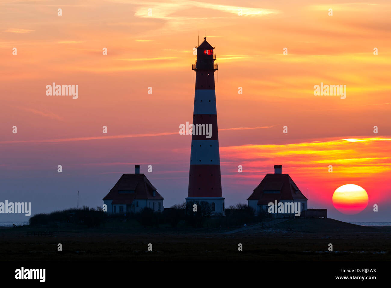 The lighthouse Westerheversand at sunset. Peninsula of Eiderstedt, North Frisia, Germany Stock Photo