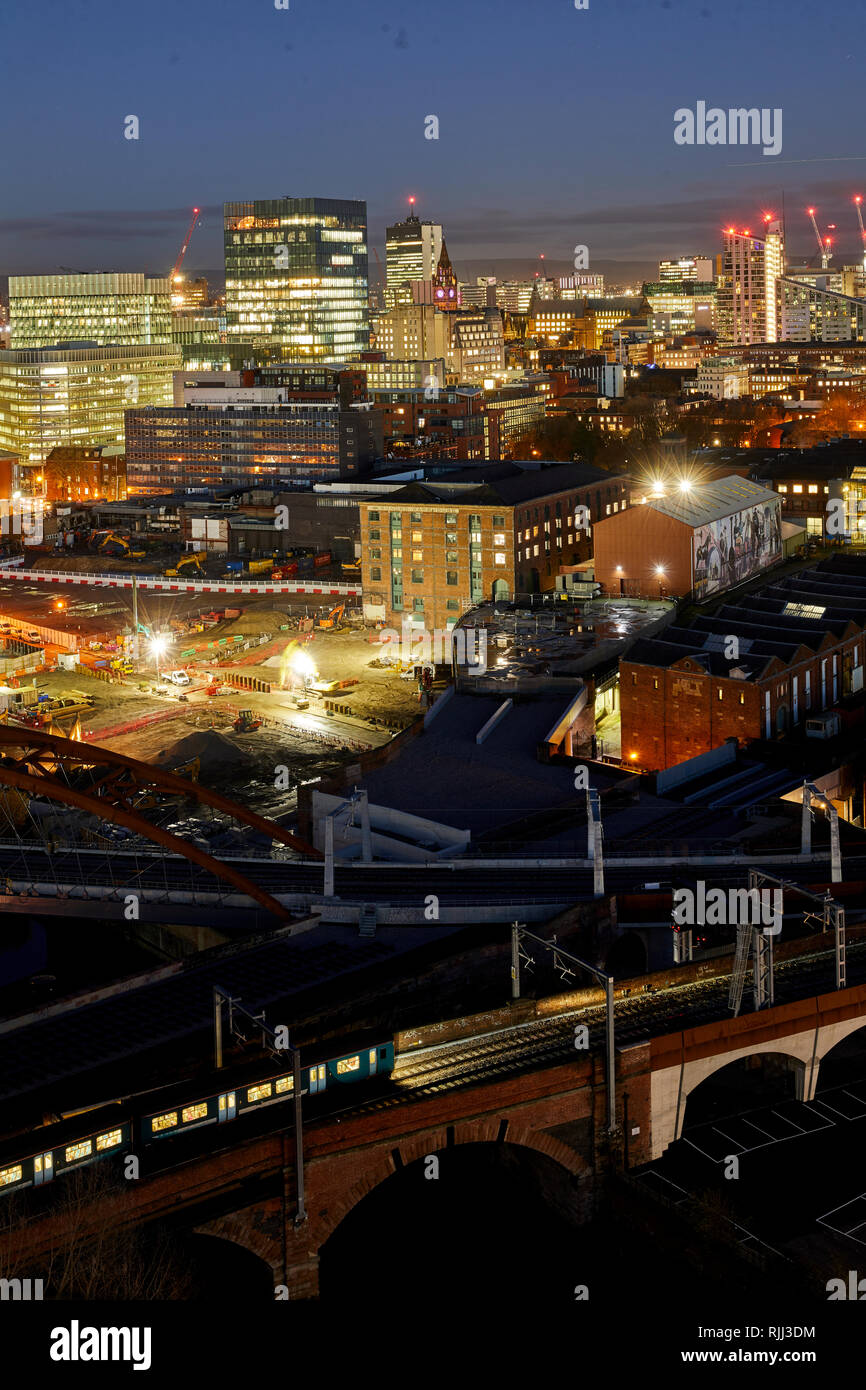 Manchester city centre skyline view across the rooftops from Salford