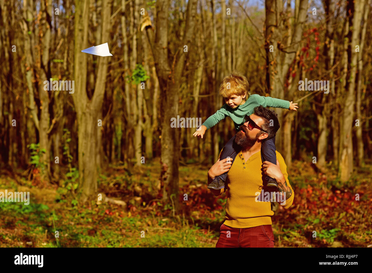 Little boy dream to fly high on fathers shoulder. Father and son launch