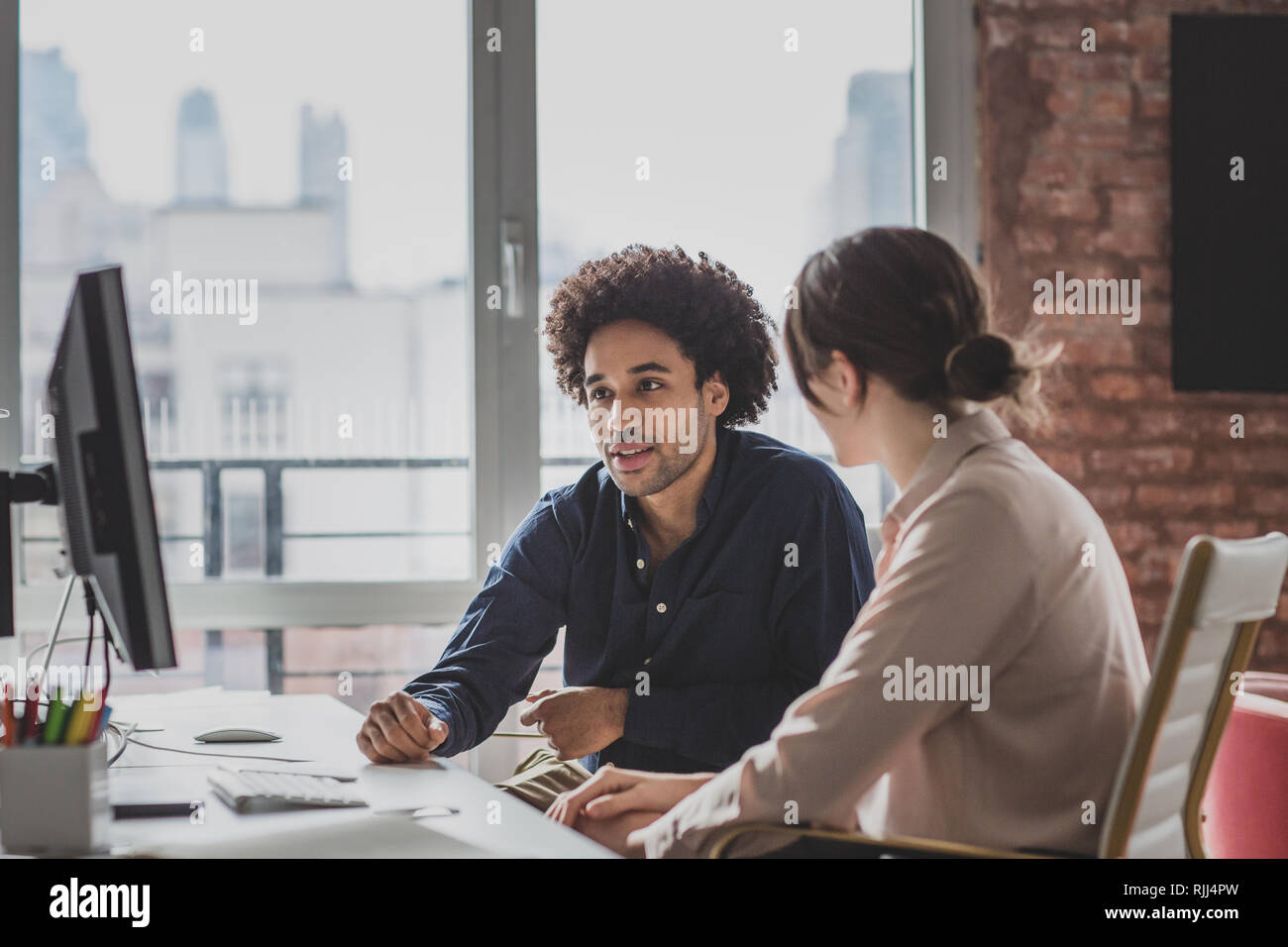 Coworkers working together in an office Stock Photo