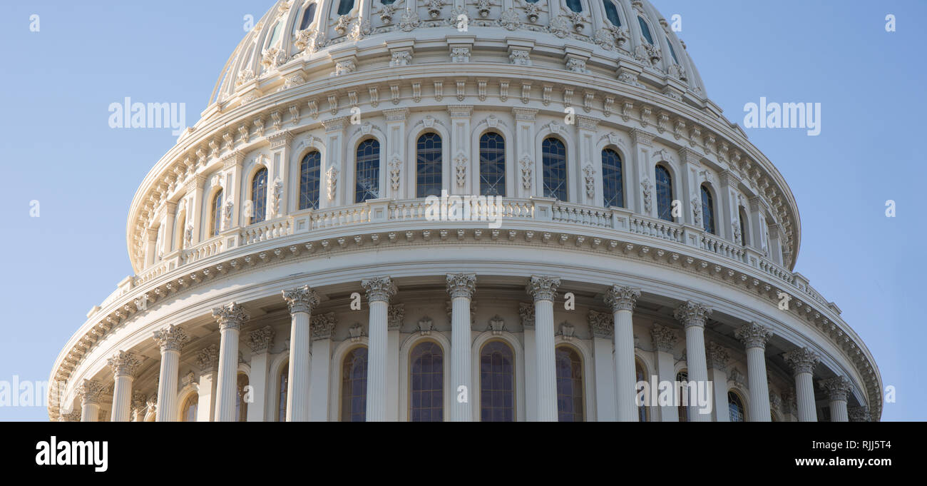 The US Capitol Building rotunda in Washington, D.C. hit with late afternoon sunlight and a bright blue sky. Stock Photo