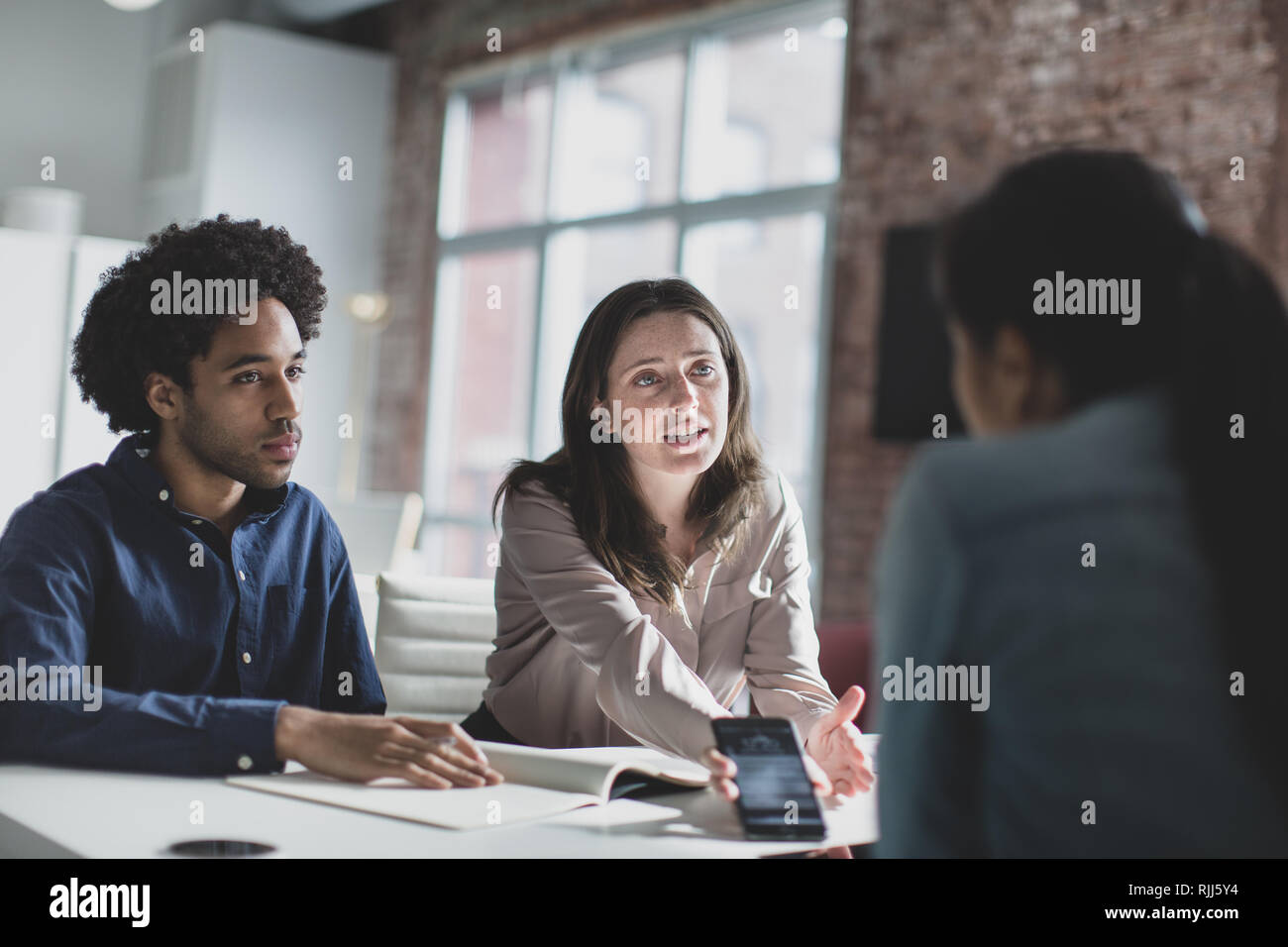 Smartphone app developers in a business meeting Stock Photo