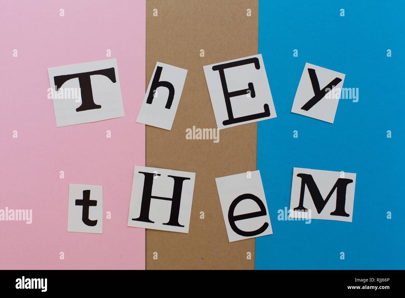 The words 'they' and 'them' in cut out letters. Stock Photo