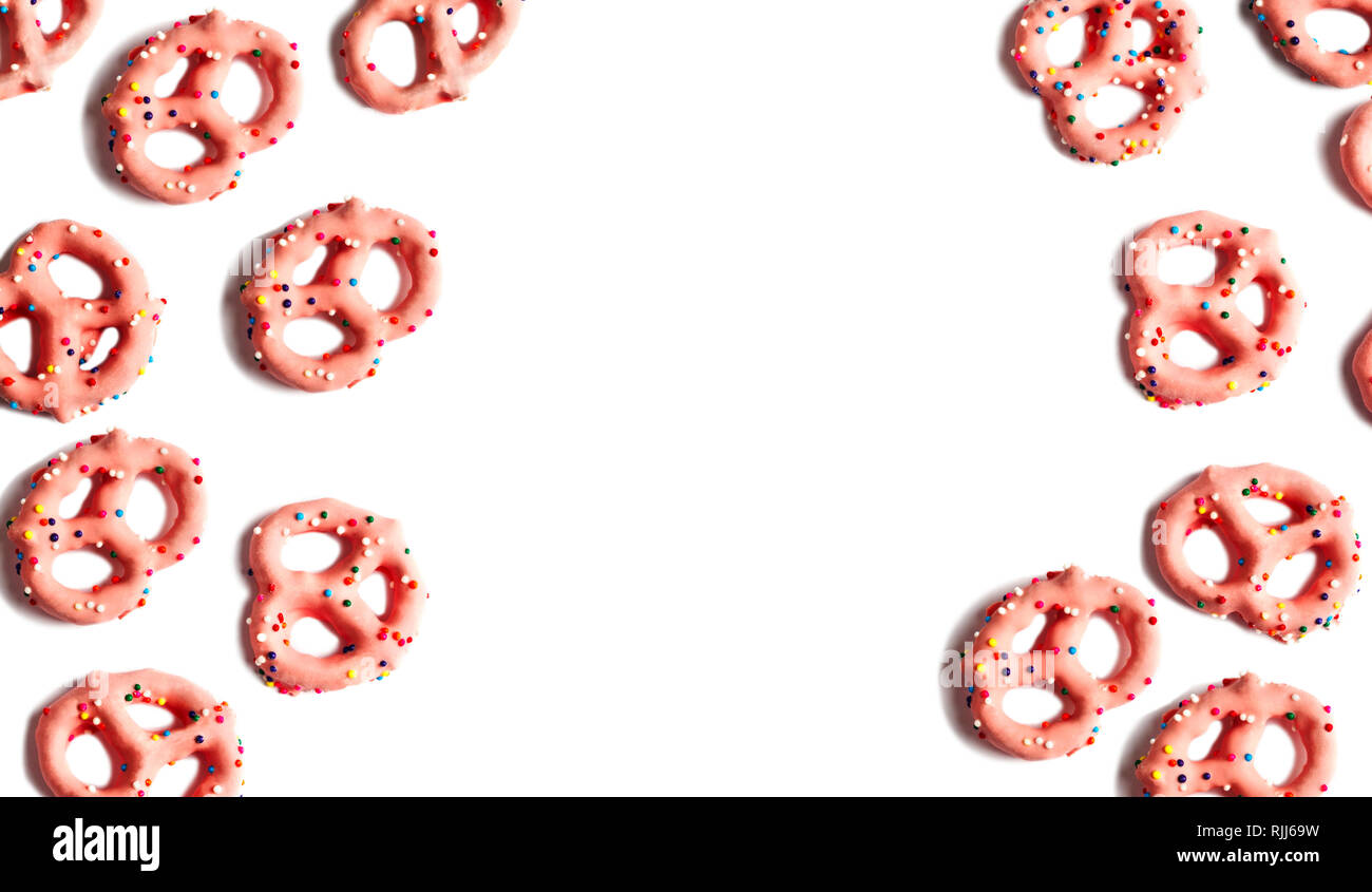 Strawberry flavoured yogurt covered pretzels on white background Stock