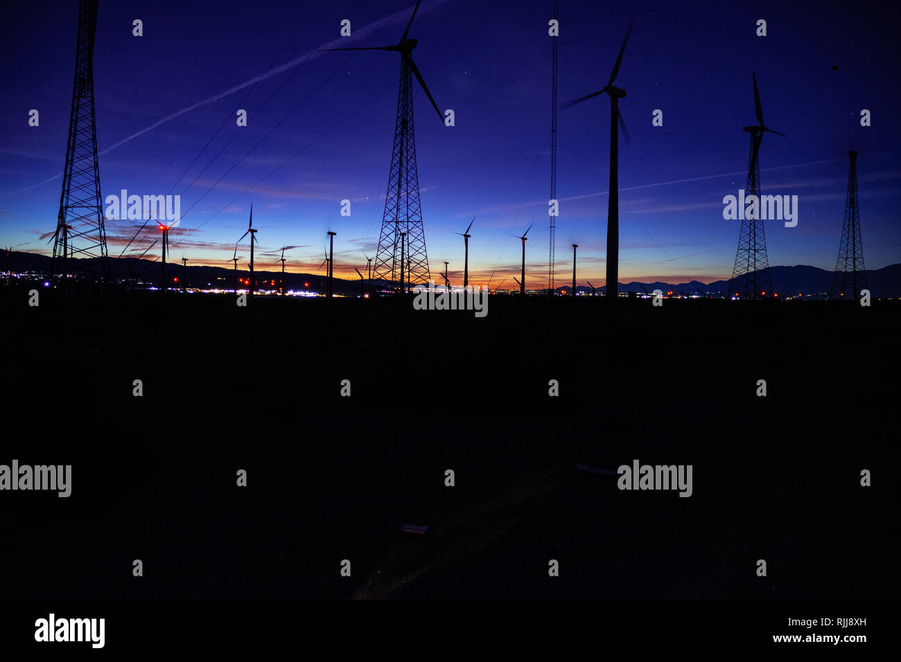 Blue light sunrise with wind turbines Stock Photo