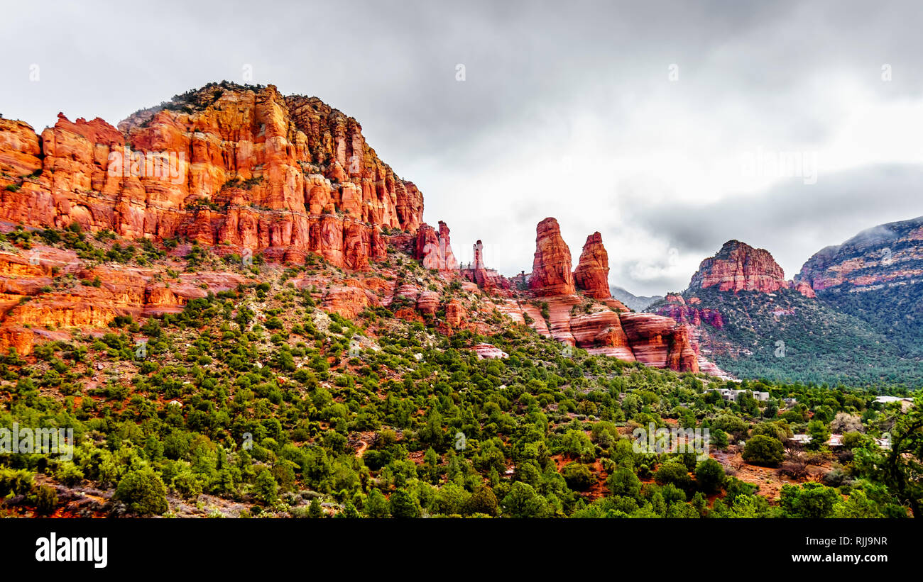Rain pouring down on the geological formations of the red sandstone buttes surrounding the Chapel of the Holy Cross at Sedona in northern Arizona, USA Stock Photo
