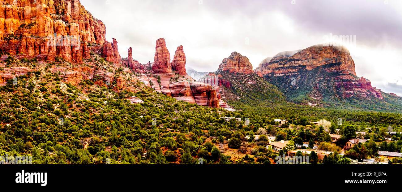 Rain pouring down on the geological formations of the red sandstone buttes surrounding the Chapel of the Holy Cross at Sedona in northern Arizona, USA Stock Photo