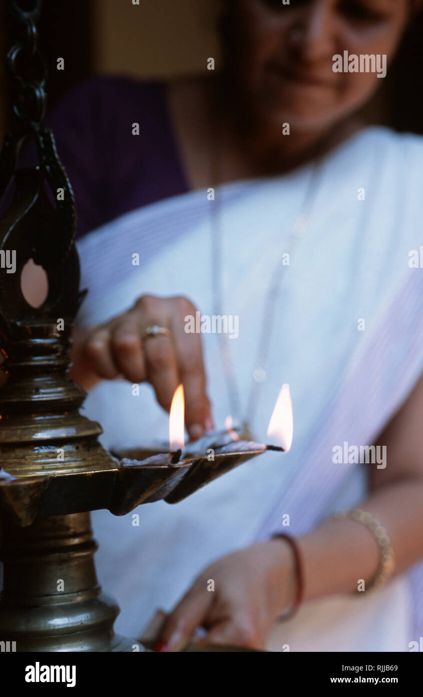 Lighting the spa's oil burner at Kumarakom Lake Resort in Kerala. Set on the bank of Lake Vembanad - a bird sanctuary - the resort has been created us Stock Photo