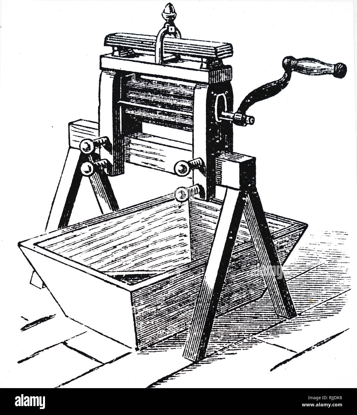 An engraving depicting a wringer or mangle used to express water. Dated 19th century Stock Photo