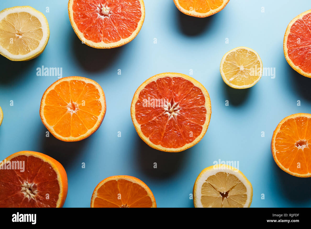 cut-in-half-juicy-citruses-on-a-blue-background-stock-photo-alamy