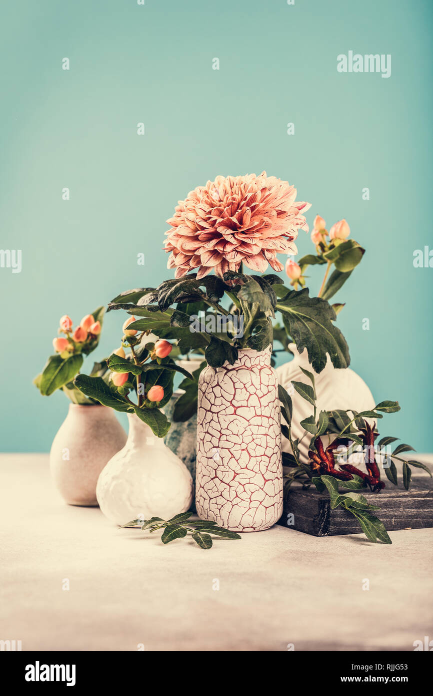 Vase with beautiful chrysanthemum flowers on light table Stock Photo