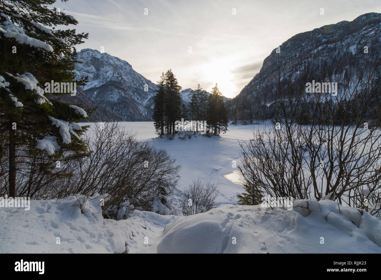 The alpine lake of Predil - Raibl in northern Italy covered by ice and snow in wintertime Stock Photo